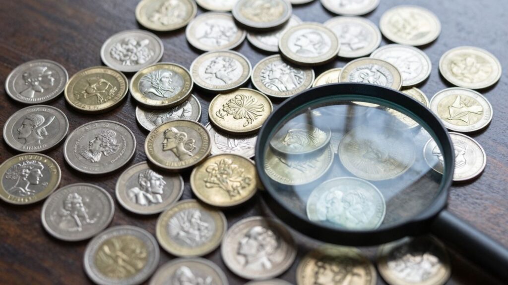 Coins and magnifying glass for coin appraisal