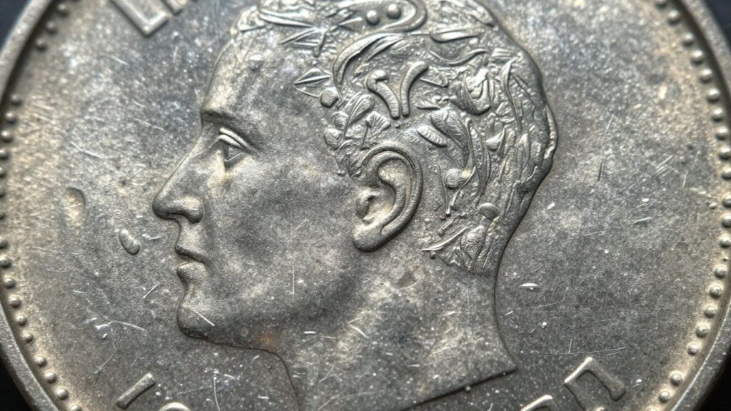 Gold coin held in hand with Tampa skyline background.