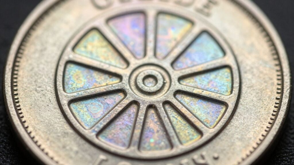 Coin surface with cartwheel luster effect.